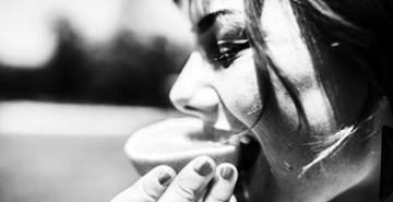 Woman Eating Orange Slice