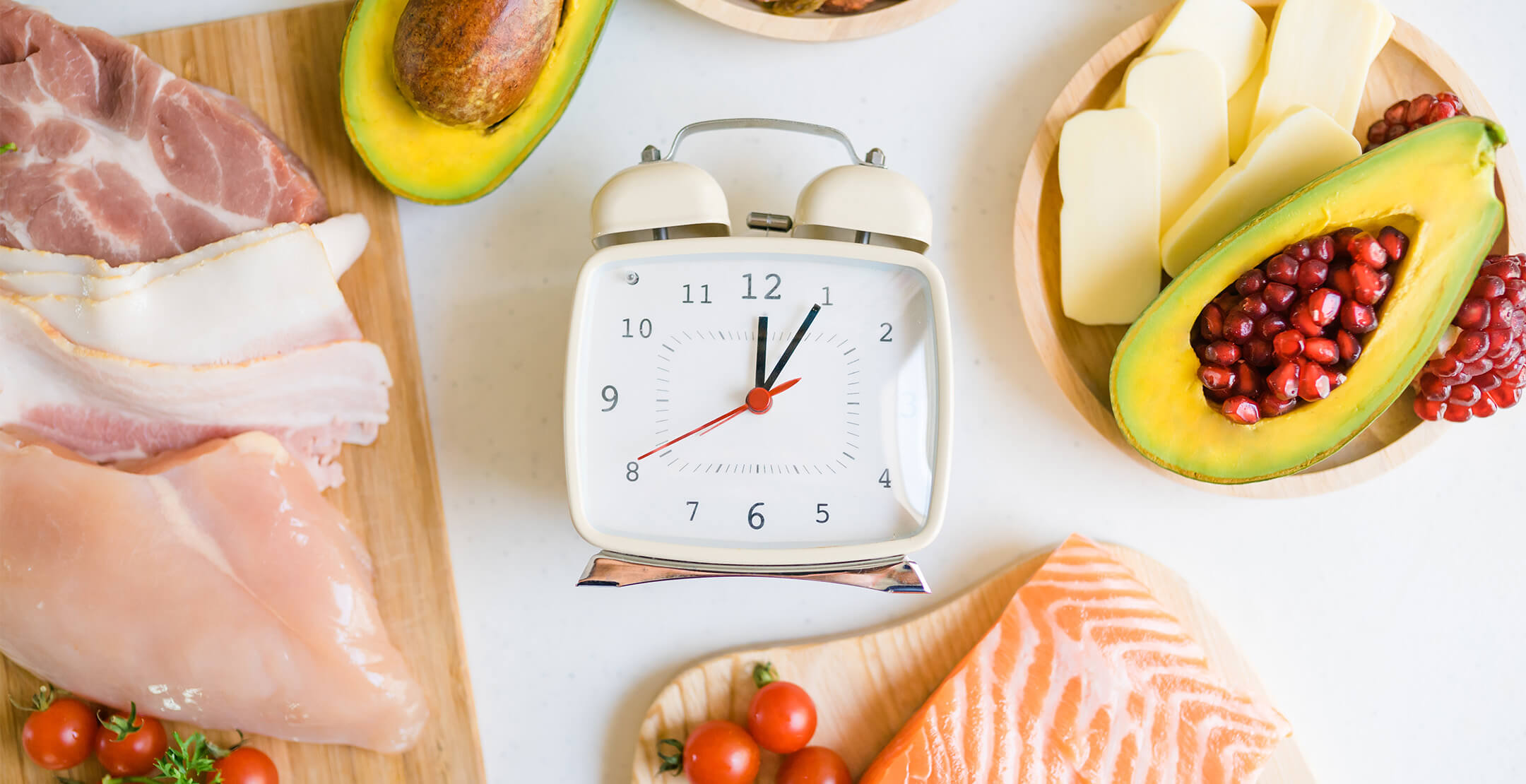 Image of clock surrounded by food items including fish and vegetables