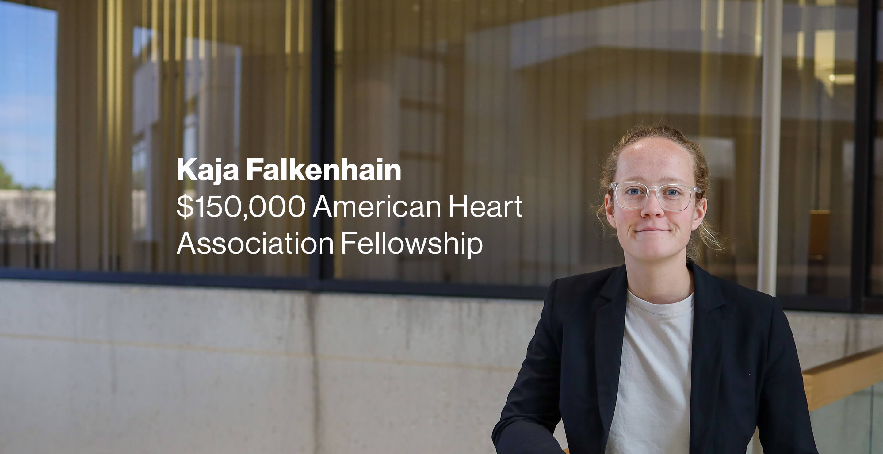 Dr. Kaja Falkenhain standing in the atrium of Pennington Biomedical's Basic Sciences Building. Next to her, words that read "$150,000 American Heart Association Fellowship."
